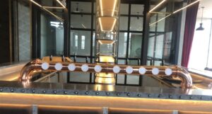 10 beer taps on copper bridge at golf club