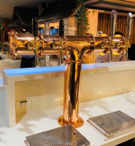 Shiny copper beer tower in steak house